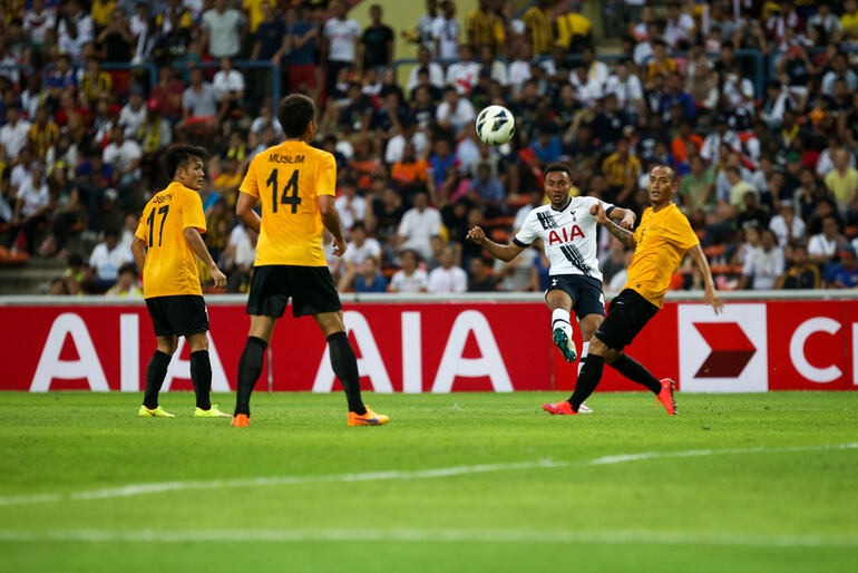 Malaysia national football team players challenge for the ball during an international match, representing a key moment from Malaysia's 2023–2026 football cycle.