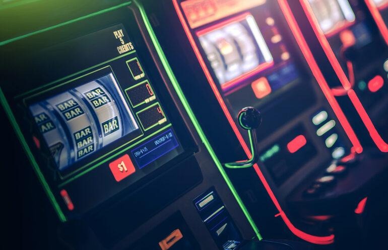 Colorful slot machines showing spinning reels, highlighting slot volatility strategies for beer-loving players and high-match promotions.