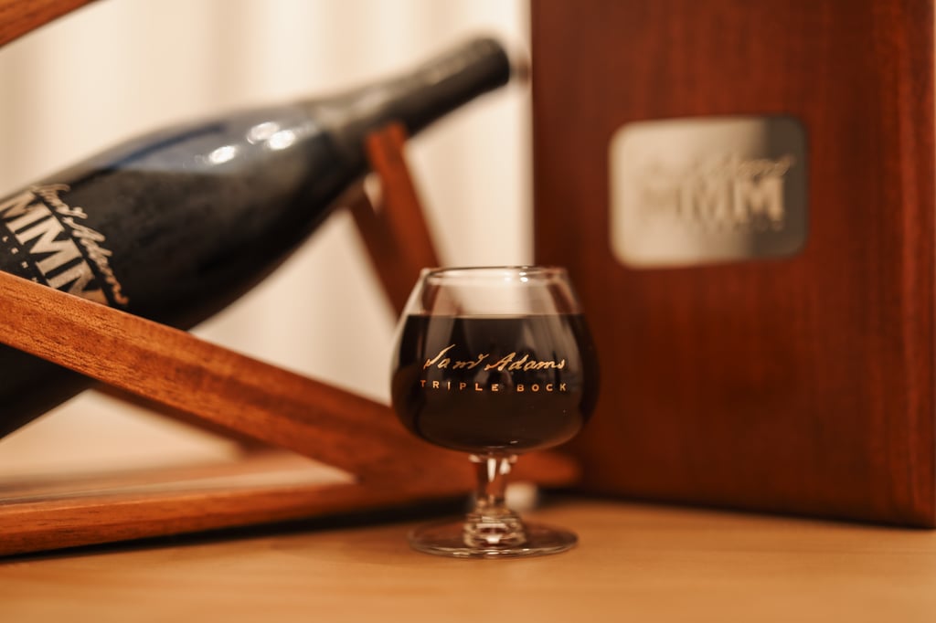 Samuel Adams Millennium in glass with bottle behind it.