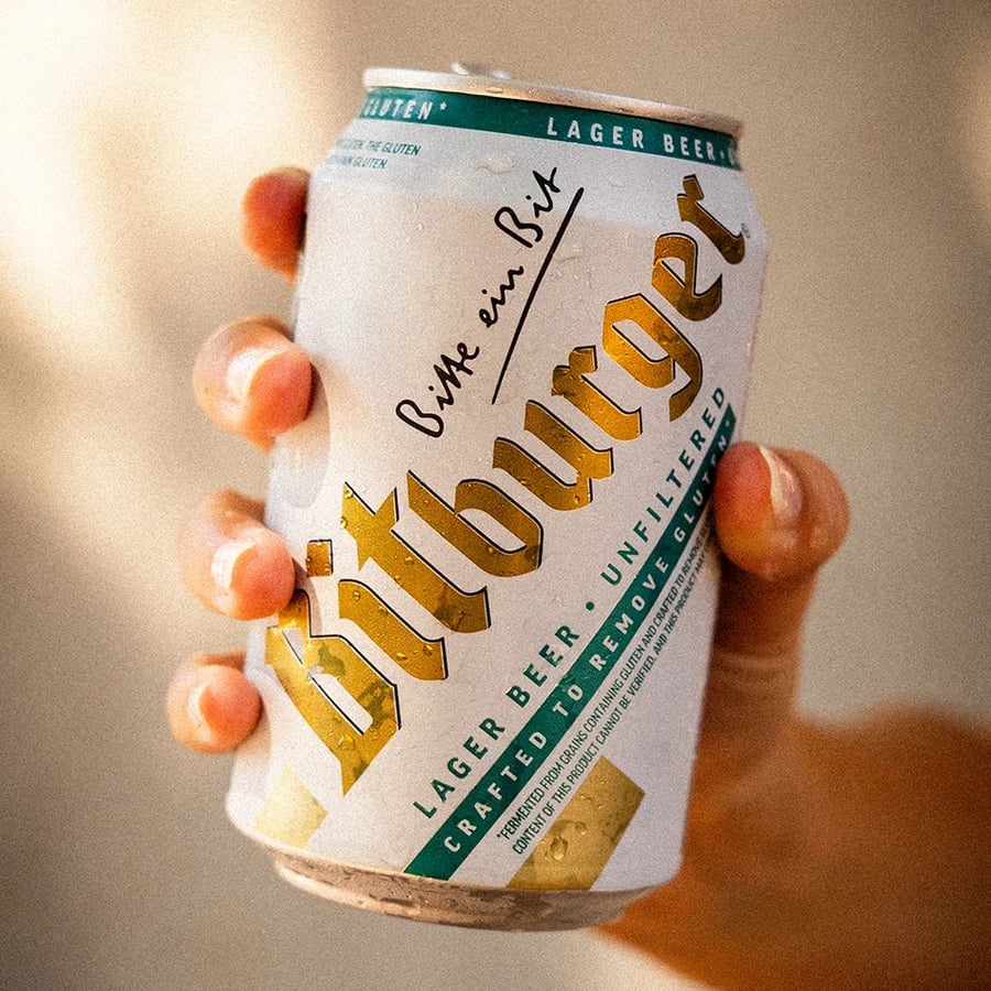 A can of Bitburger gluten-reduced beer being held by hand