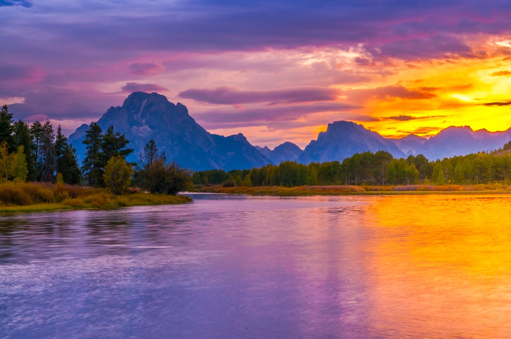 River view of Grand Teton Mountains at sunset