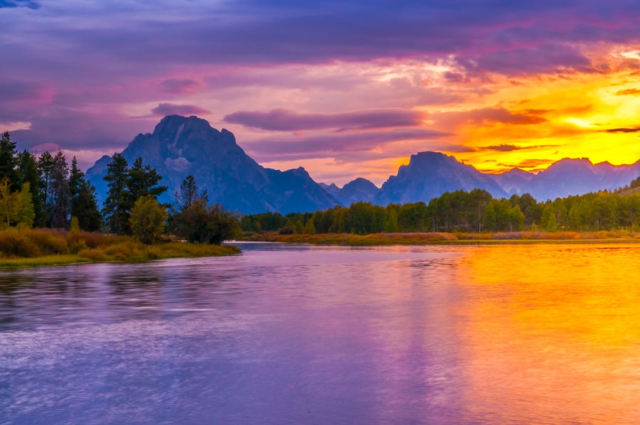 River view of Grand Teton Mountains at sunset
