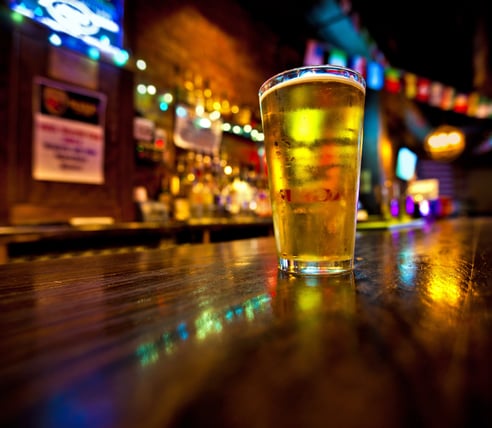 Non-alcoholic beer on bartop.