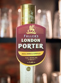Fuller's London Porter tap handle in London pub.