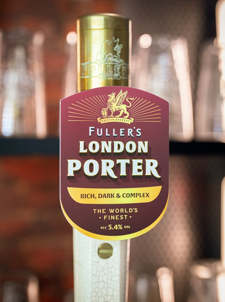 Fuller's London Porter tap handle in London pub.