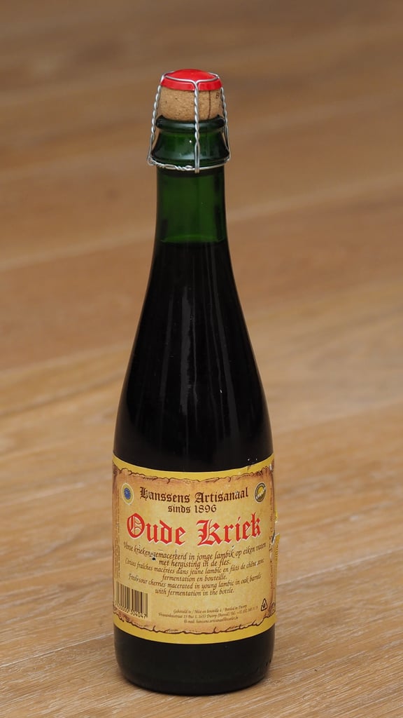 Hanssens Oude Kriek bottle on wood tabletop.