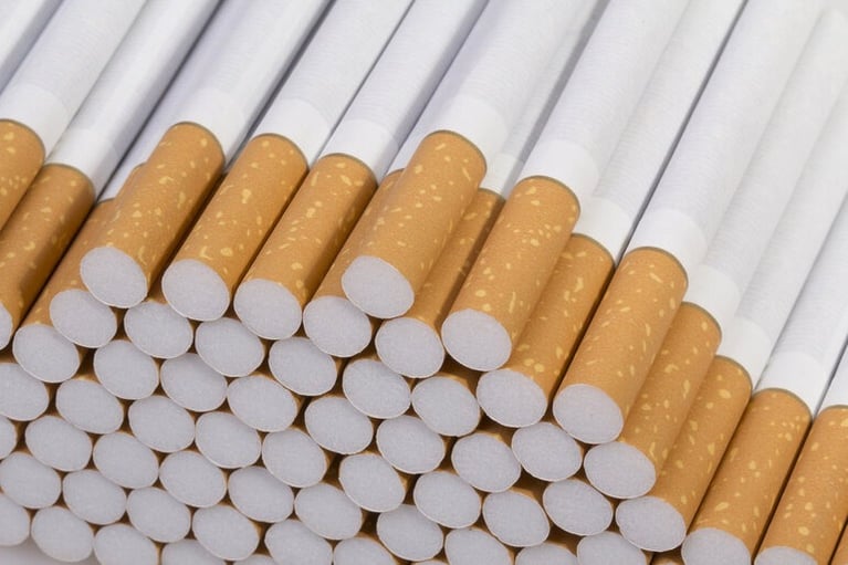 A close-up pile of Canadian cigarettes with brown filters from Smokes Canada.