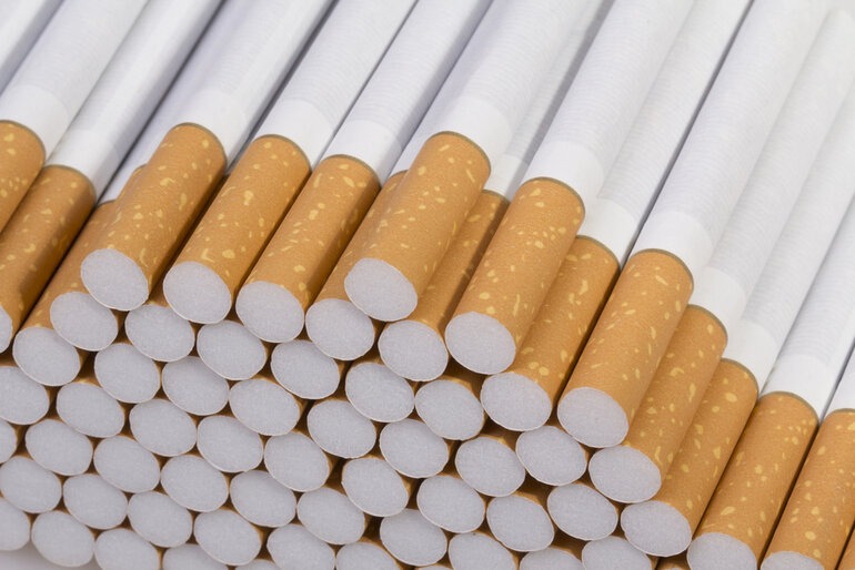 A close-up pile of Canadian cigarettes with brown filters from Smokes Canada.