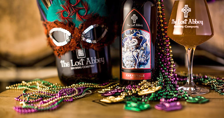 lost abbey carnevale ale tableau with masks, beads and glasses