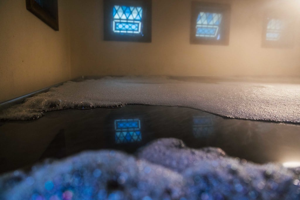 hazy room with beer fermenting in a coolship