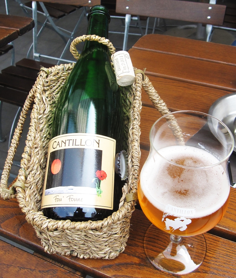 A bottle of Cantillon Fou' Foune in a lambic basket.