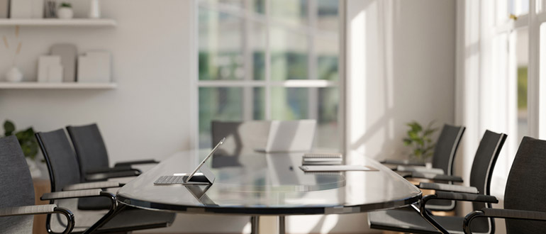 A conference table surrounded by chairs creating a professional and inviting atmosphere. 