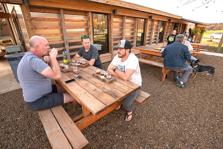 Guests enjoy mild weather while seated outside at Orthodox Farmhouse Brewery in Fayetteville, Arkansas