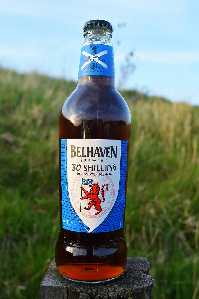 belhaven brewery 80 shilling bottle in a field of grass