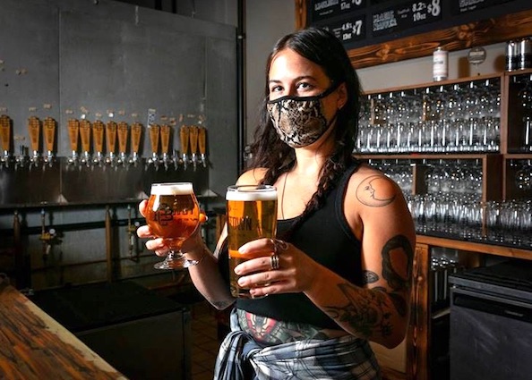 Brewery taproom server wearing a facemask