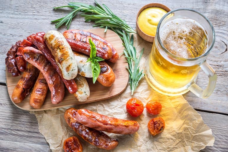 bratwurst spread with beer glass on table