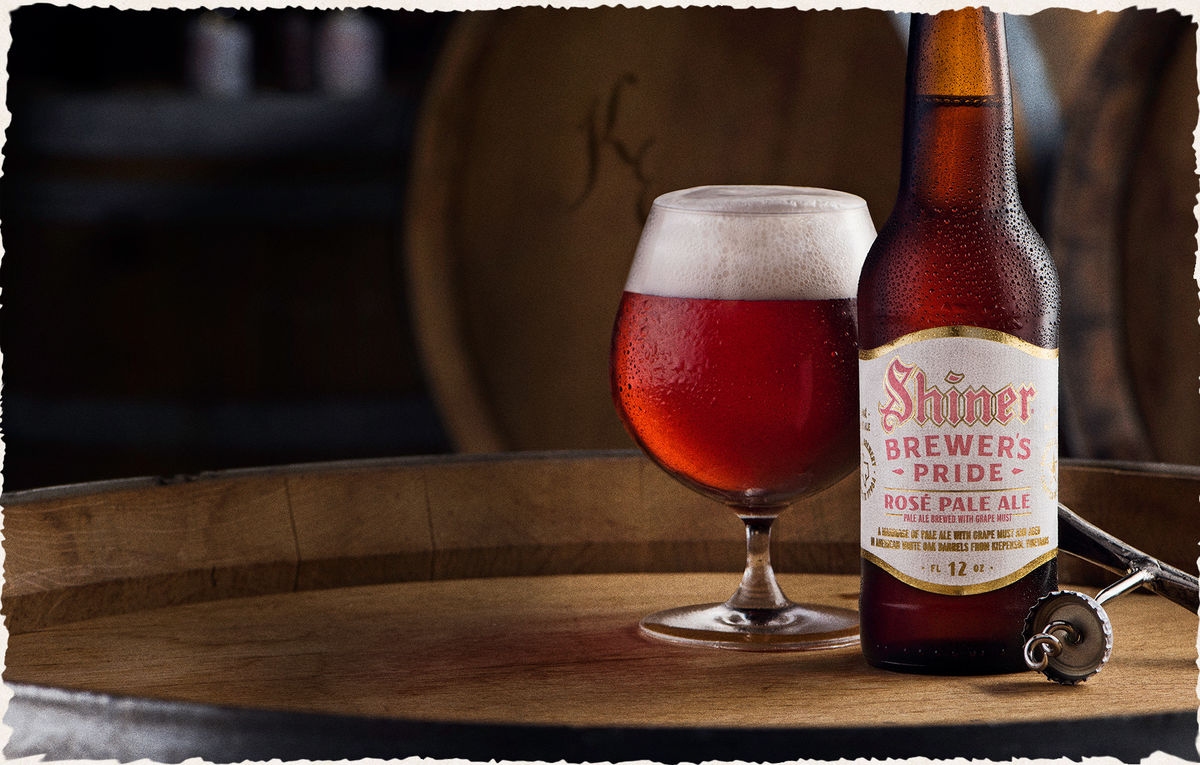 Bottle and poured glass of Shiner Brewer's Pride Rosé Pale Ale