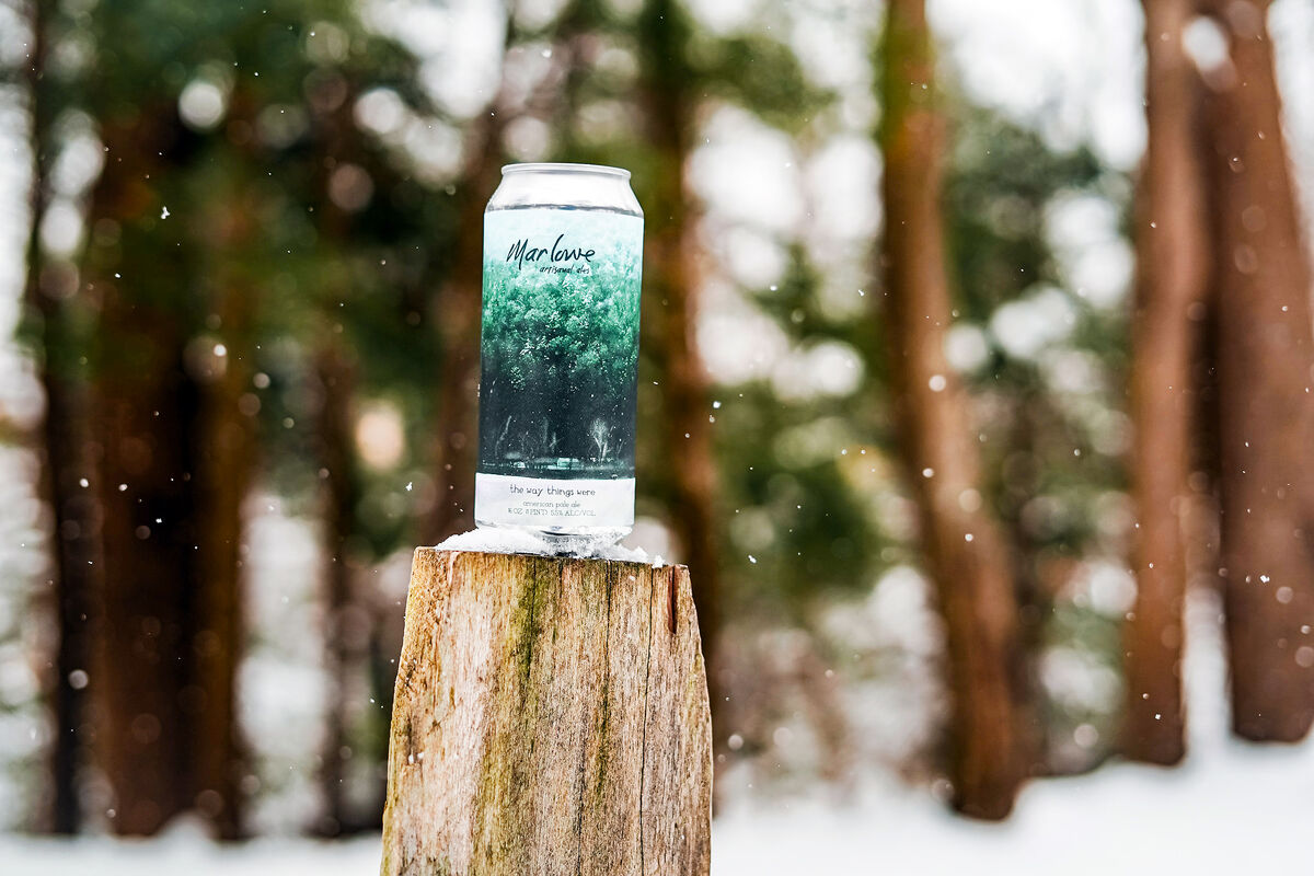beer photography in the snow on wood block