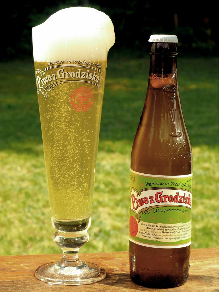 Grodziskie beer in glass and bottle on picnic table