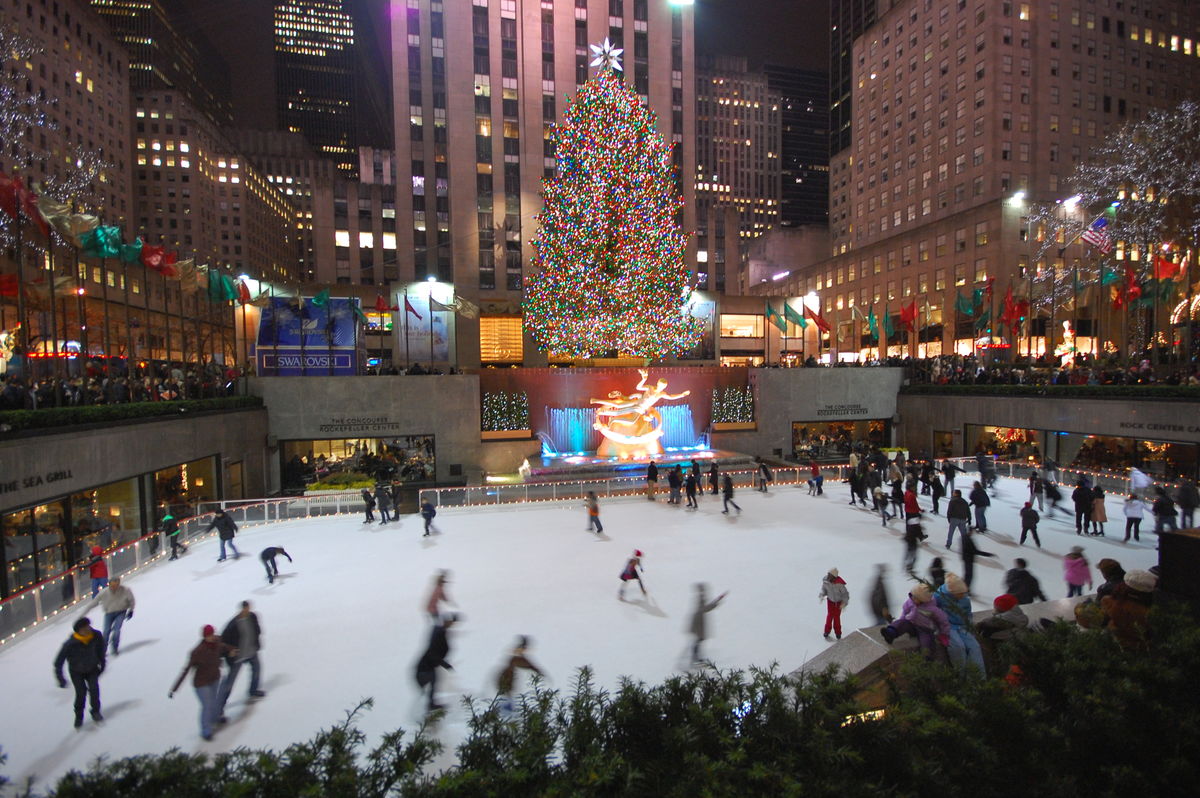 people ice skating at rockefeller plaza during christmas