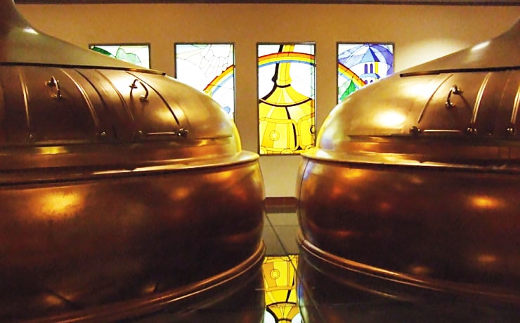 brasserie d'orval fermentation tanks in front of stained glass