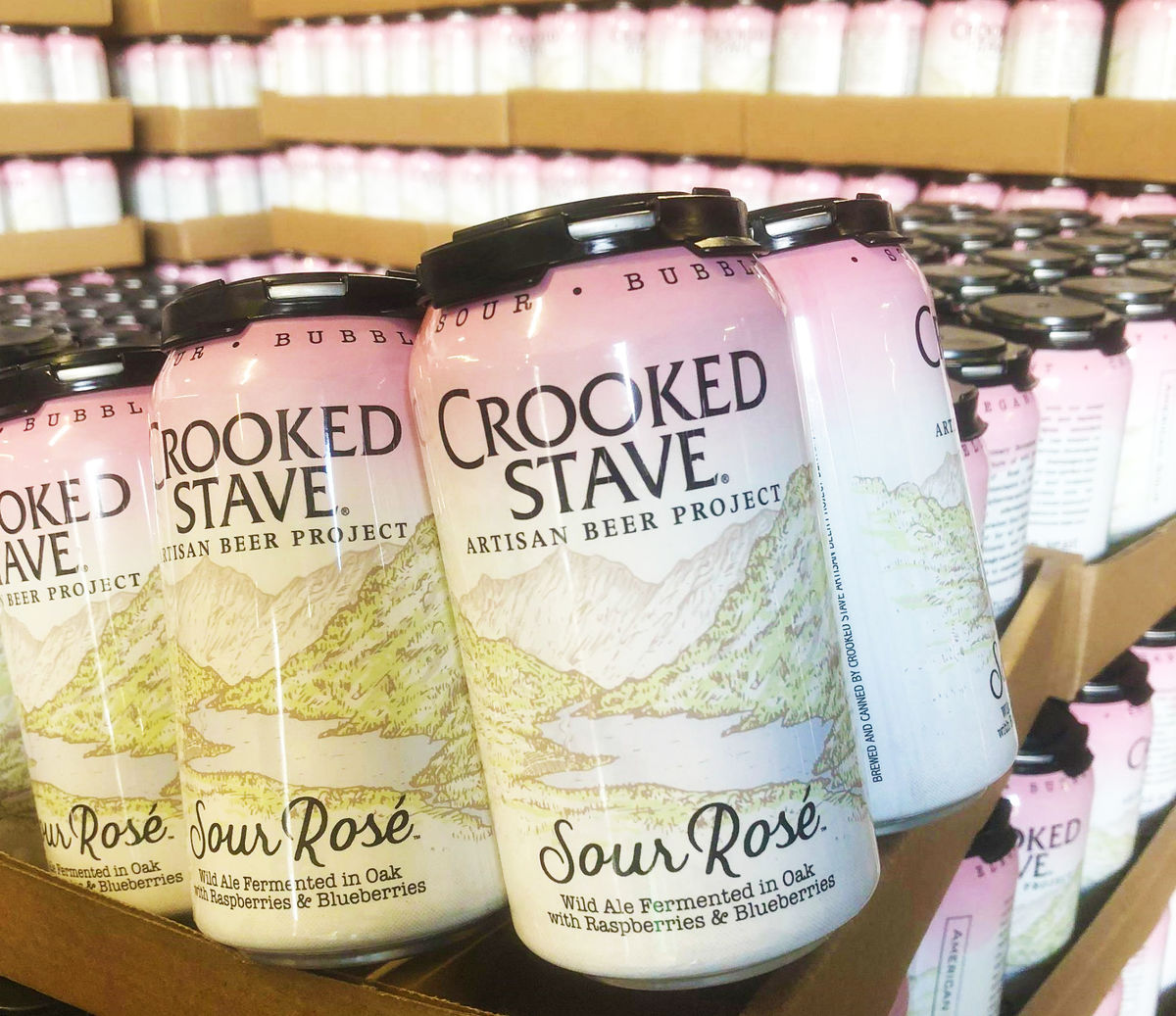 Cans of Crooked Stave Artisna Beer Project's Sour Rosé  - Wild Ale Fermented in Oak with Rasberries & Blueberries