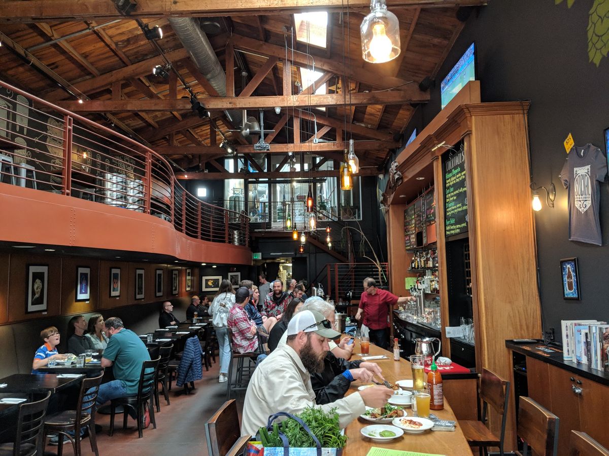 Patrons drinking and dinning at Social Kitchen & Brewery
