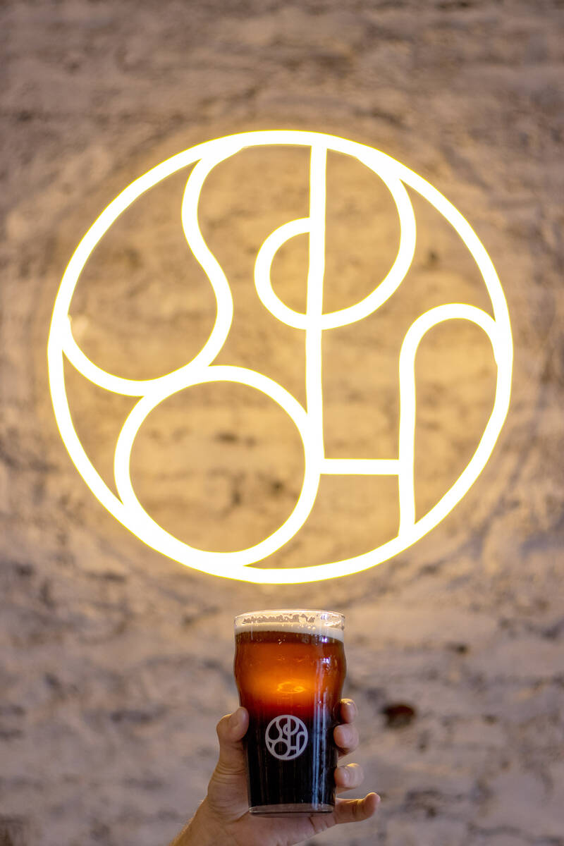 beer from Spoh in front of signage