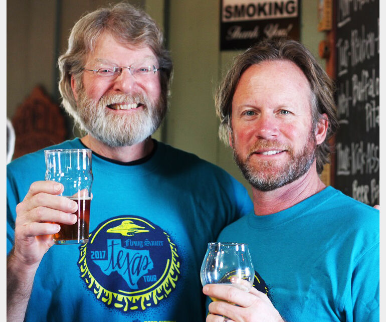 Mike Hagan of Mike-Ro-Brewery and Keith Schlabs of Flying Saucer hoist a glass to craft beer in 2017.