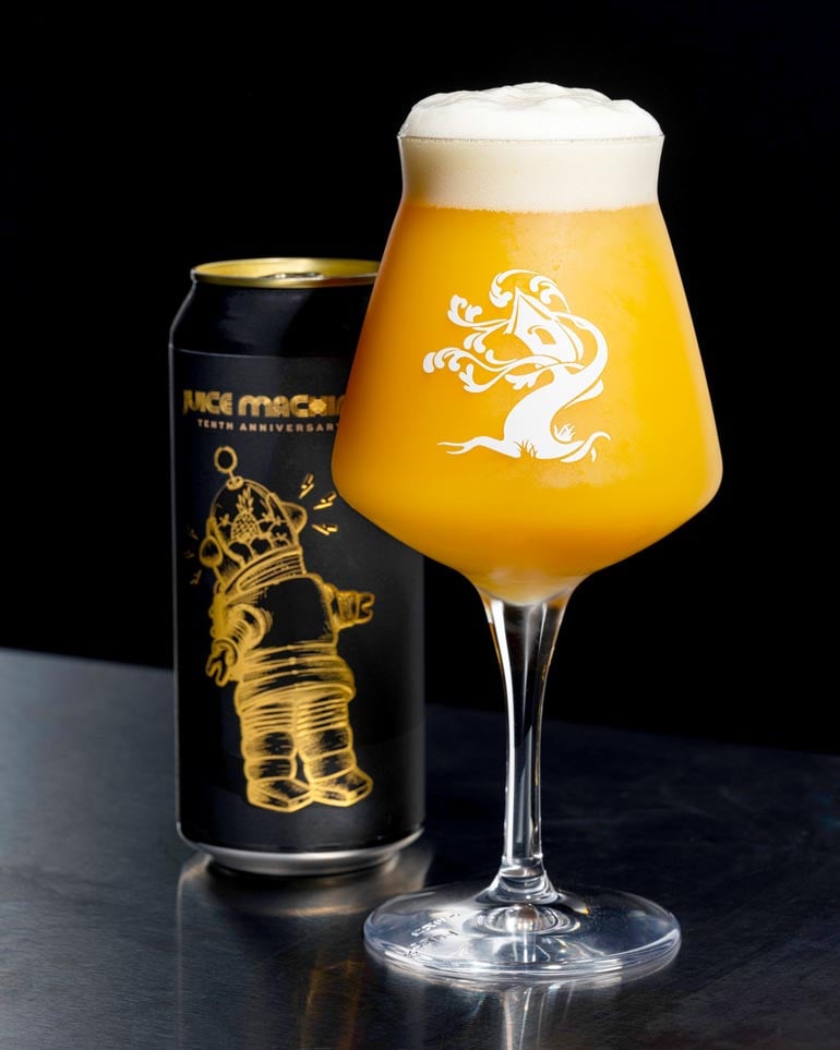 tree house brewing teku glass full of juice machine 10th anniversary with can behind it