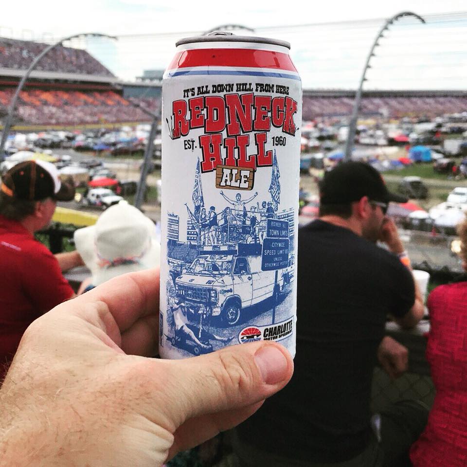 Man holding a Redneck Hill Ale at the Charlotte Motor Speedway 