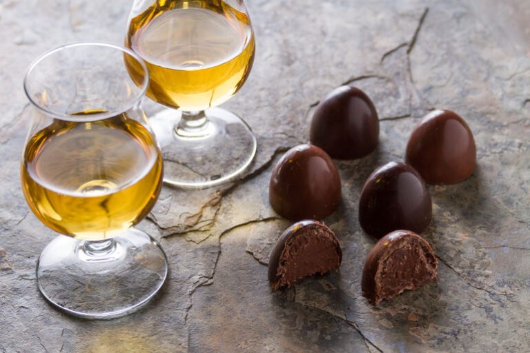 Glasses of golden beer paired with rich chocolate truffles