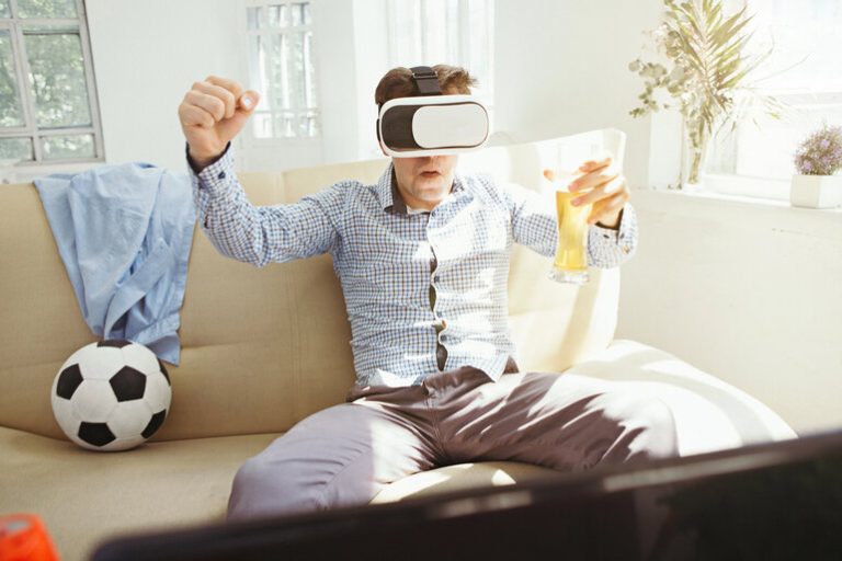 Man Enjoying Futuristic AR Gaming Experience with Beer in Hand