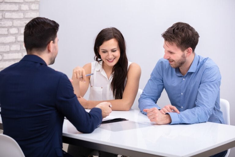 A professional real estate agent discussing property details with clients