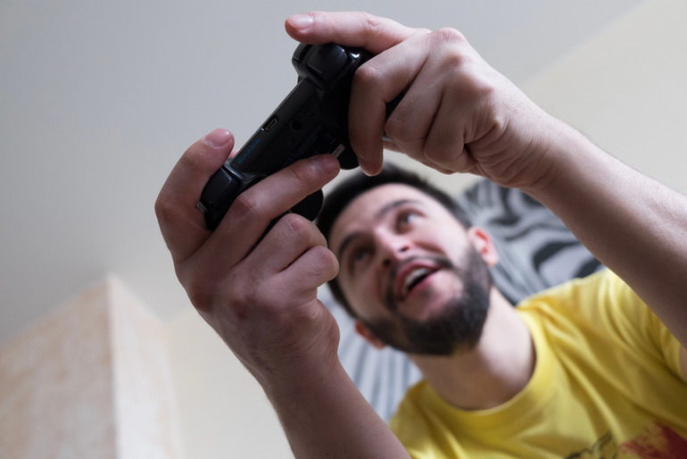 Man holding a remote controller.