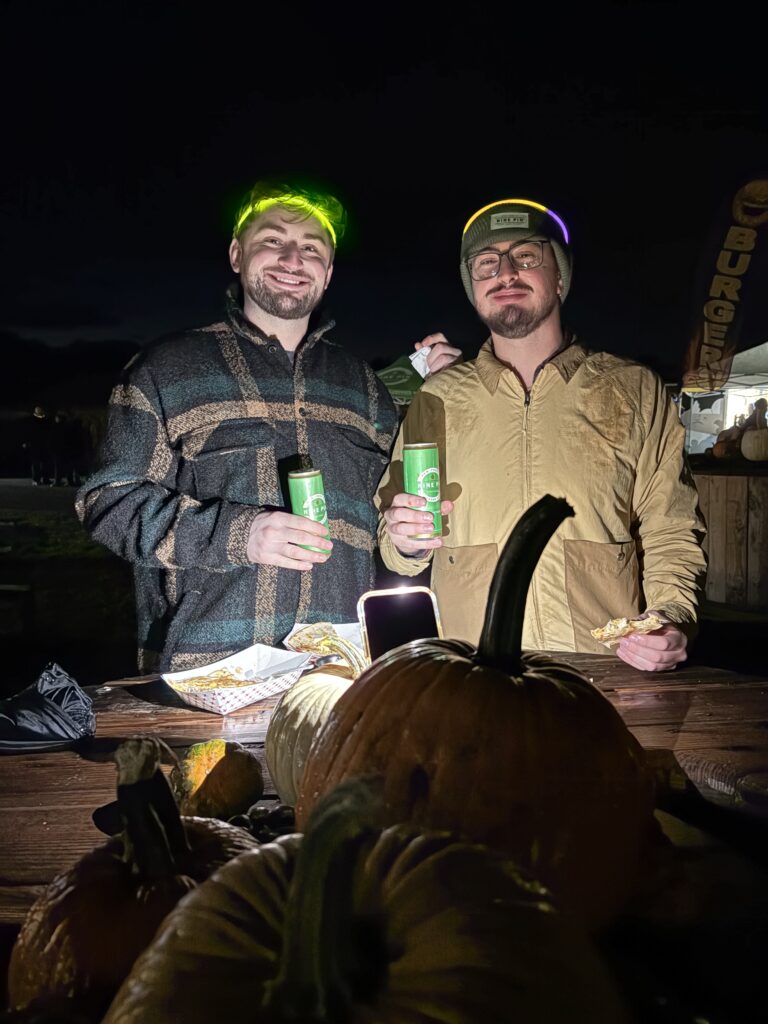 Two people enjoying Nine Pin Ciderworks cider at a Halloween event